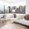 a room with a couch and a window with a view of a city